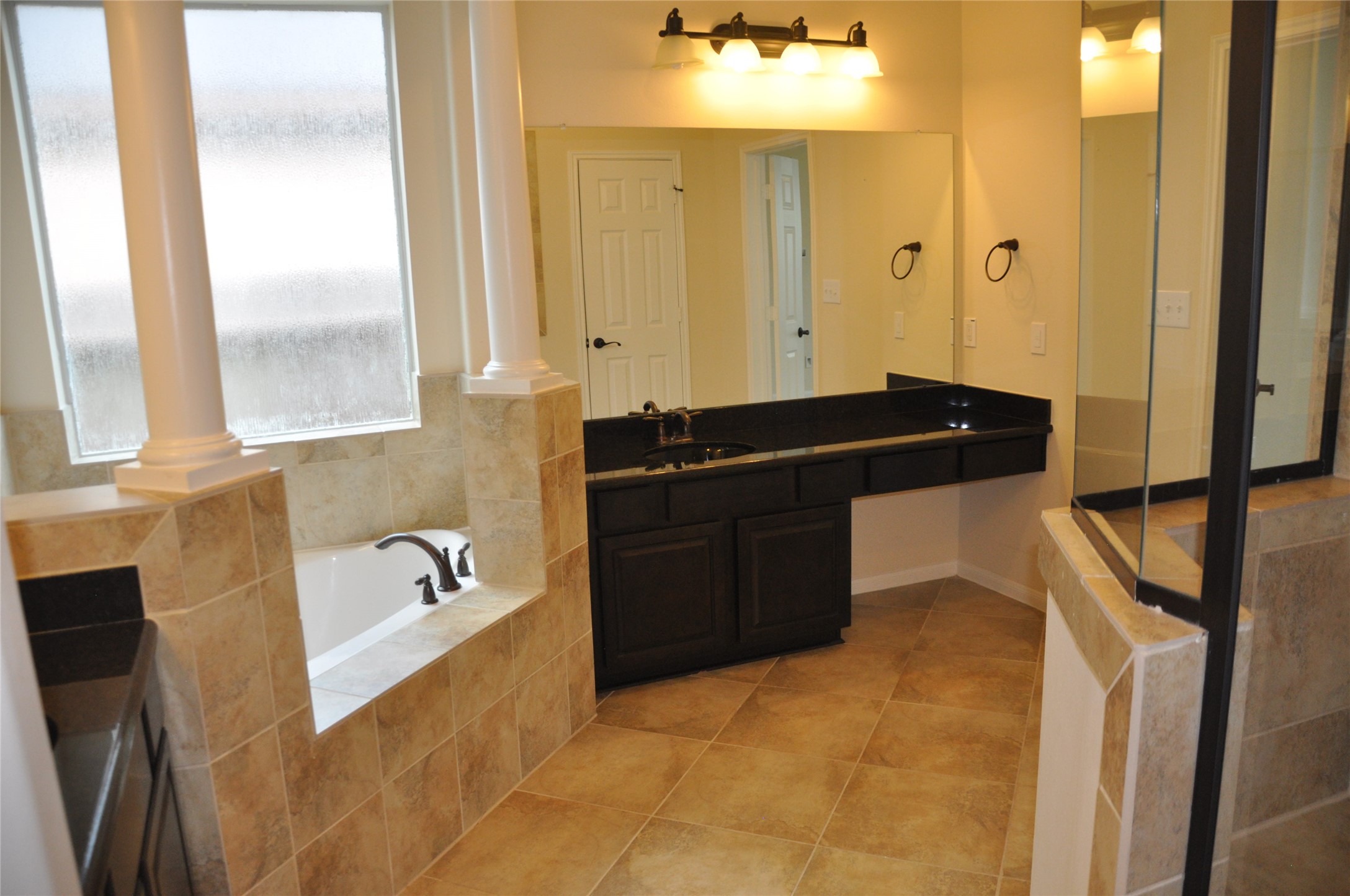 8161 Tranquil Lake Way Conroe, TX 77385 - Photo 18 of 20 a bathroom with a bathtub sink and mirror