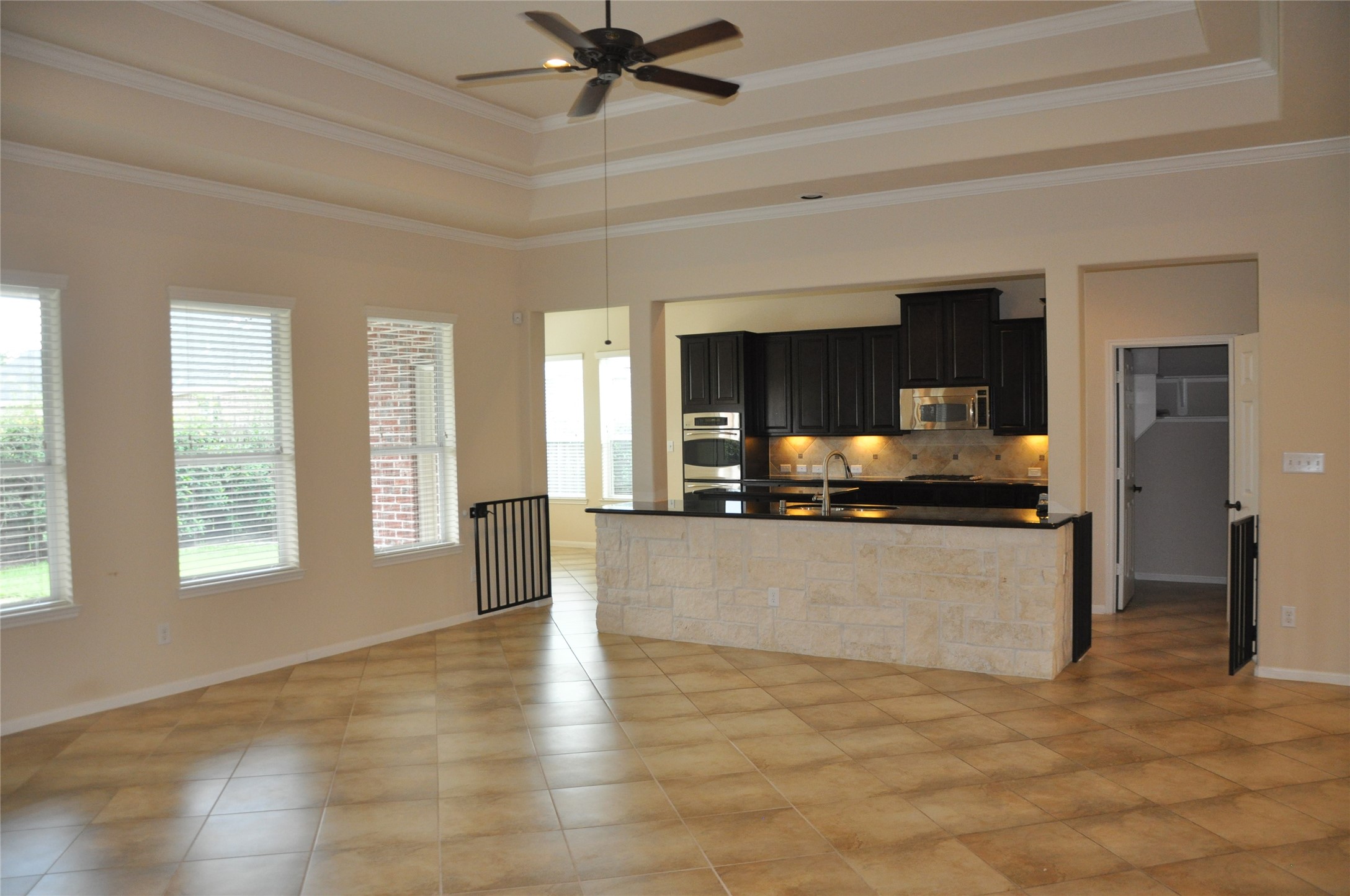 8161 Tranquil Lake Way Conroe, TX 77385 - Photo 19 of 20 a view of a living room with hardwood floor and a ceiling fan