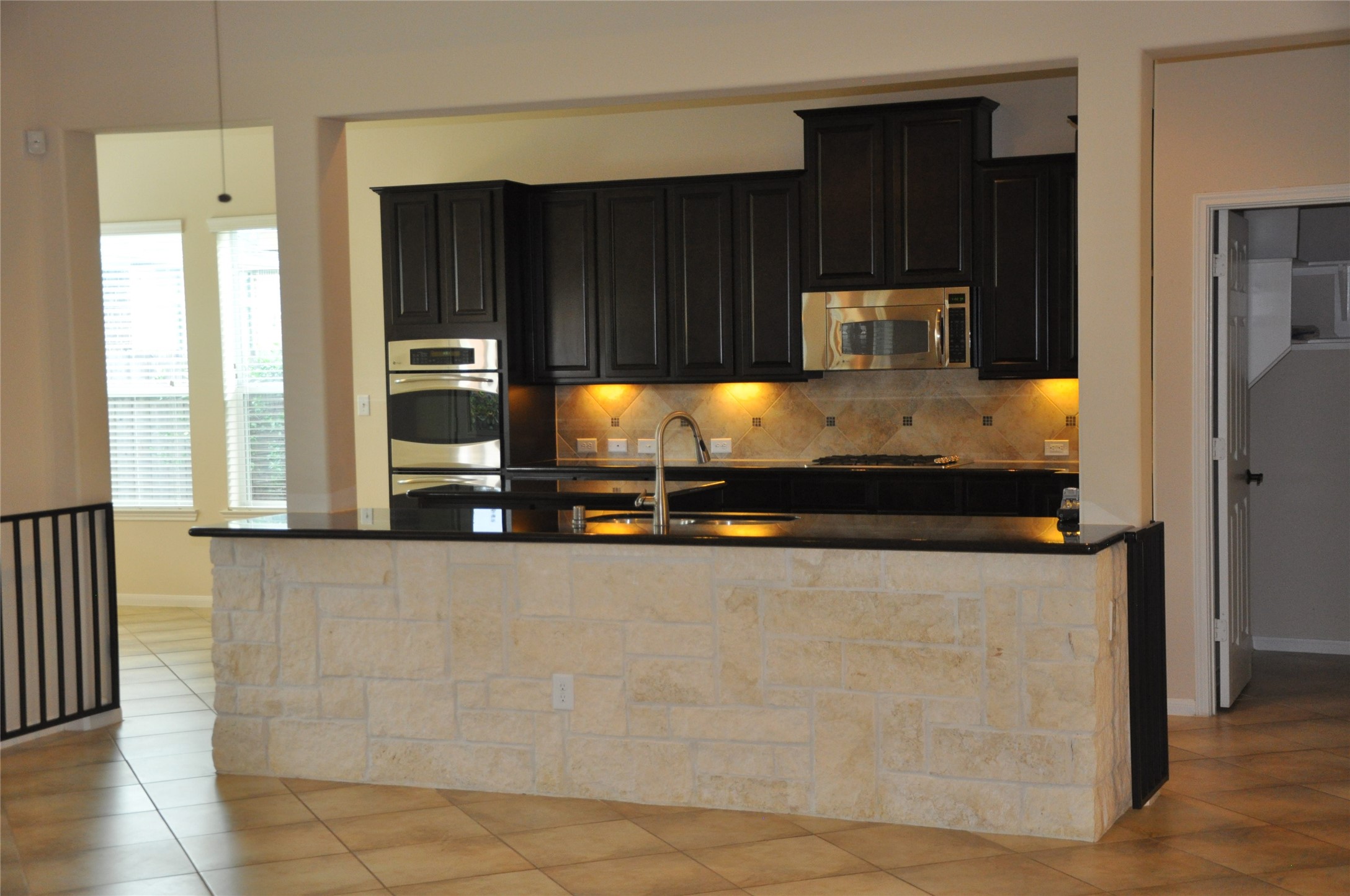8161 Tranquil Lake Way Conroe, TX 77385 - Photo 20 of 20 a kitchen with stainless steel appliances granite countertop a refrigerator and a stove