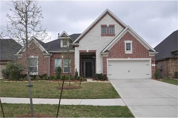8161 Tranquil Lake Way Conroe, TX 77385 - Photo 2 of 20 a front view of a house with a yard
