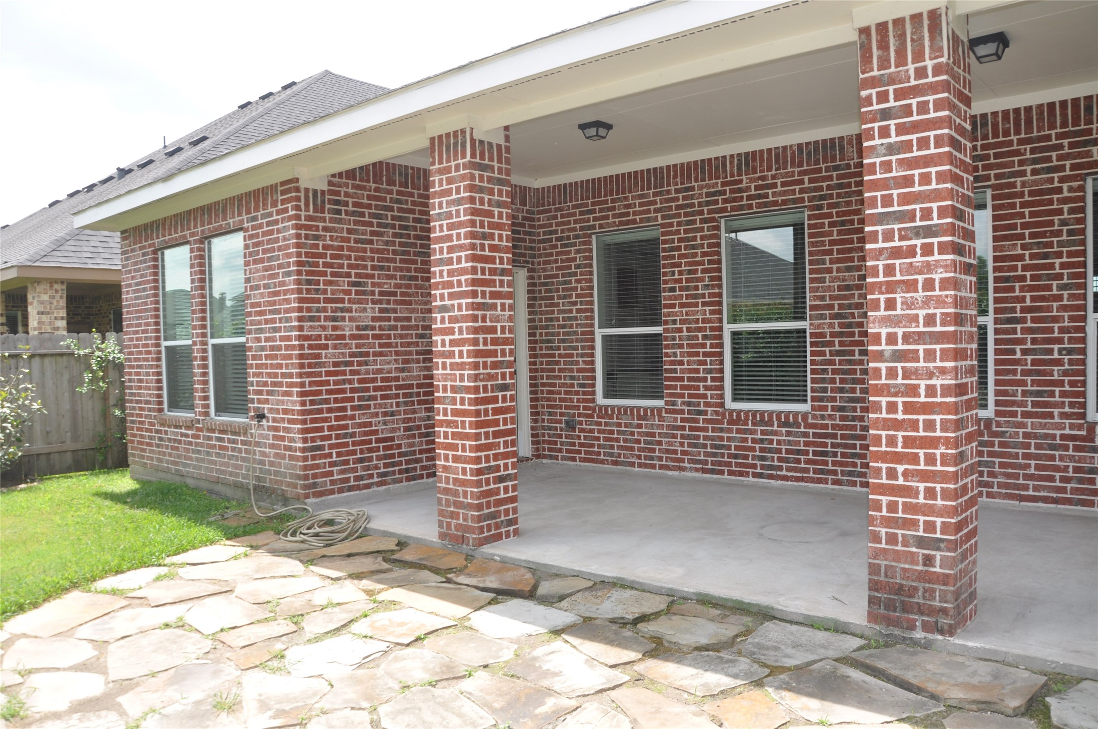8161 Tranquil Lake Way Conroe, TX 77385 - Photo 5 of 20 a view of a brick house with many windows