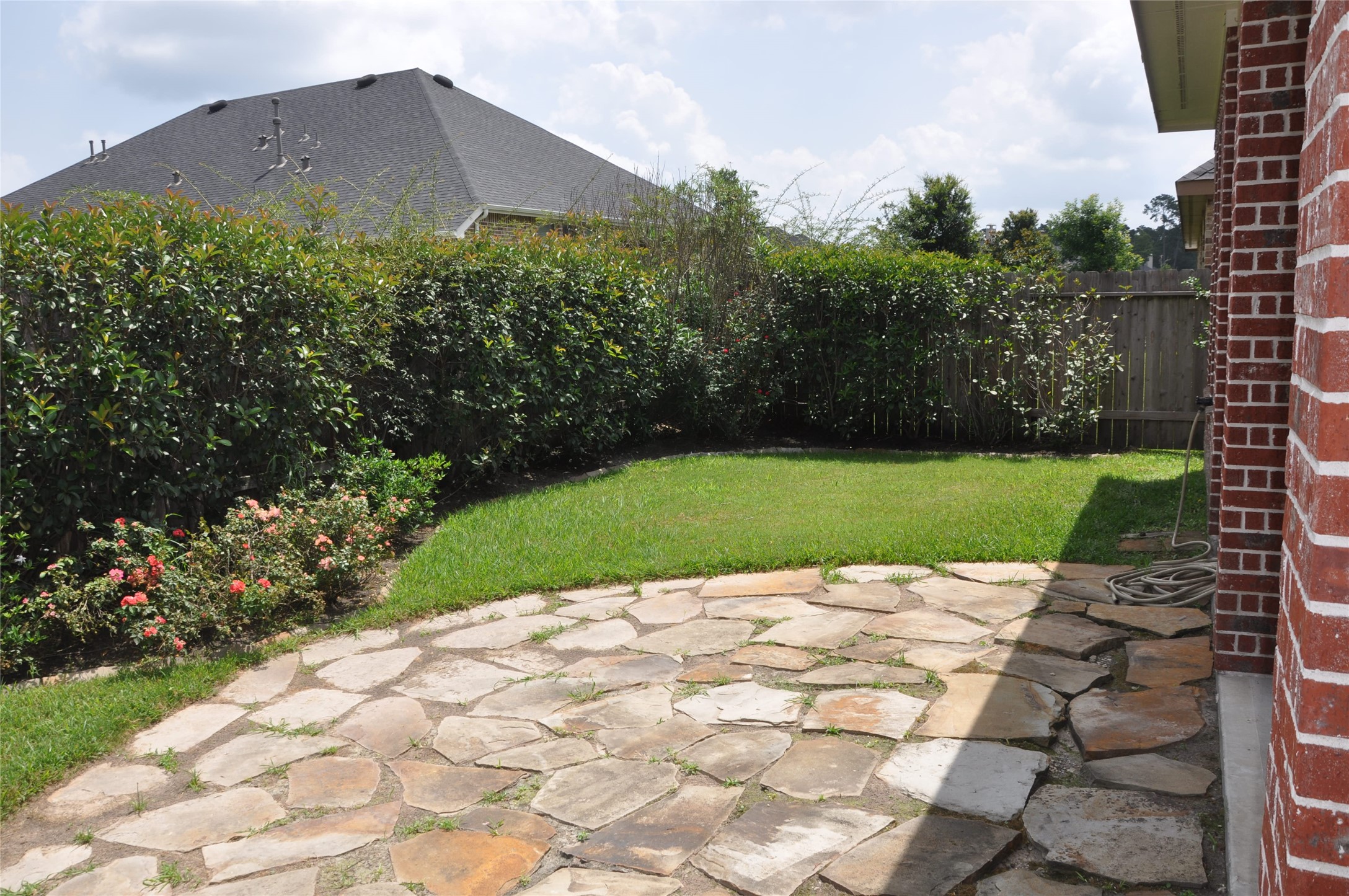 8161 Tranquil Lake Way Conroe, TX 77385 - Photo 6 of 20 a view of a garden with a building in the background