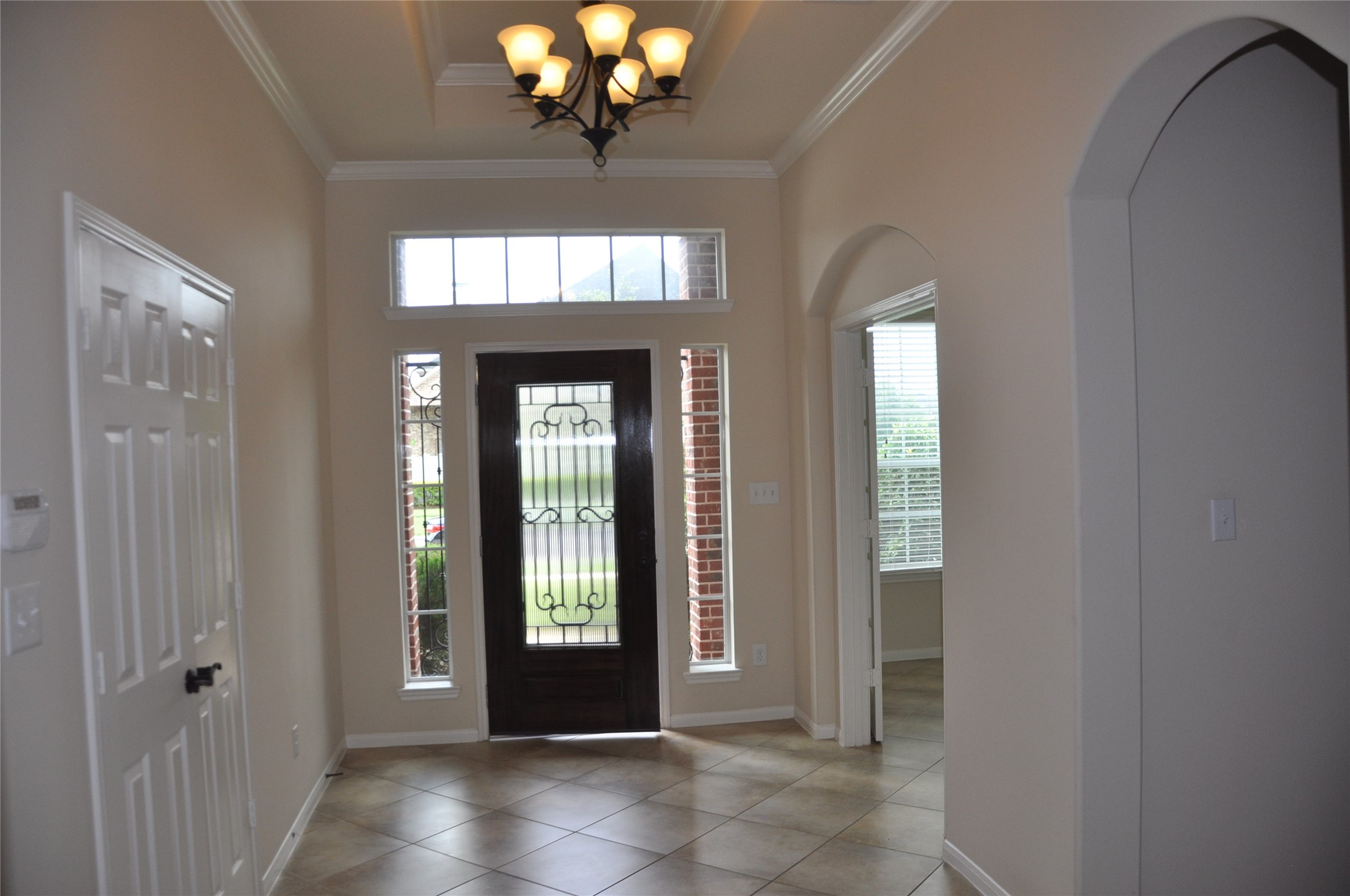 8161 Tranquil Lake Way Conroe, TX 77385 - Photo 7 of 20 a view of a livingroom with a chandelier fan and windows