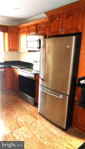 a metallic refrigerator freezer sitting in a kitchen