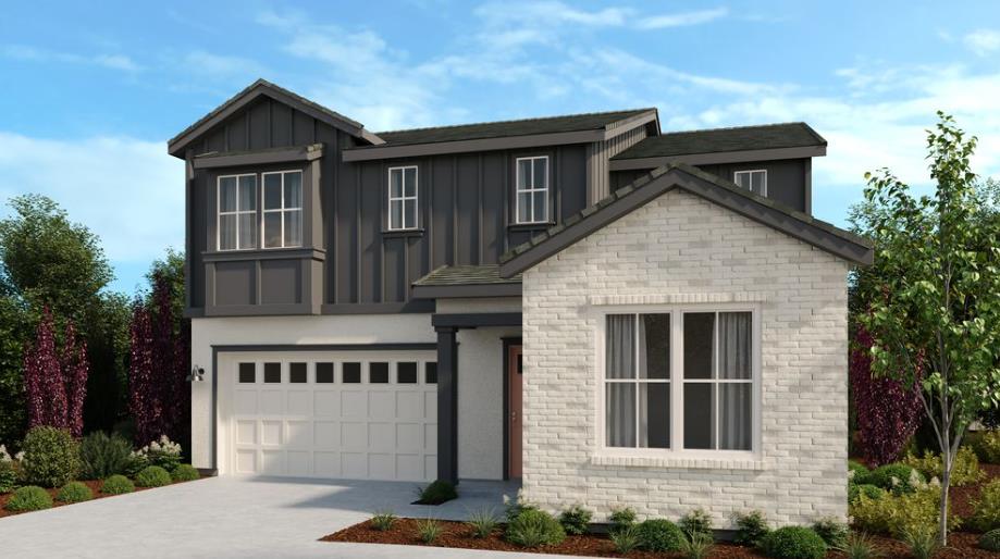 a front view of a house with plants