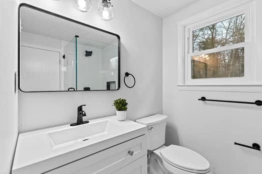 221 Plain Street Hanover, MA 02339 - Photo 15 of 29 a bathroom with a sink a toilet and mirror