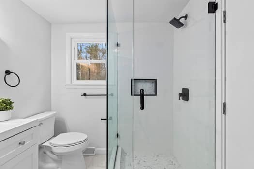 221 Plain Street Hanover, MA 02339 - Photo 16 of 29 a bathroom with a toilet sink a shower and a mirror