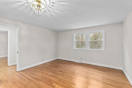 221 Plain Street Hanover, MA 02339 - Photo 20 of 29 a view of an empty room with wooden floor and a window