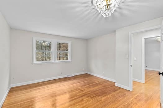 221 Plain Street Hanover, MA 02339 - Photo 21 of 29 a view of an empty room with wooden floor and a window