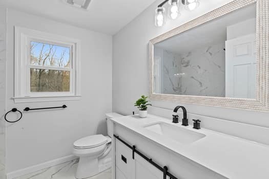 221 Plain Street Hanover, MA 02339 - Photo 22 of 29 a bathroom with a sink mirror and toilet