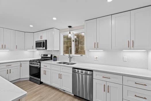 221 Plain Street Hanover, MA 02339 - Photo 10 of 29 a kitchen with a sink stove and microwave