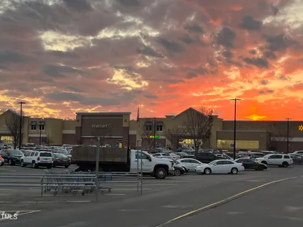 a view of a cars park in front of a building