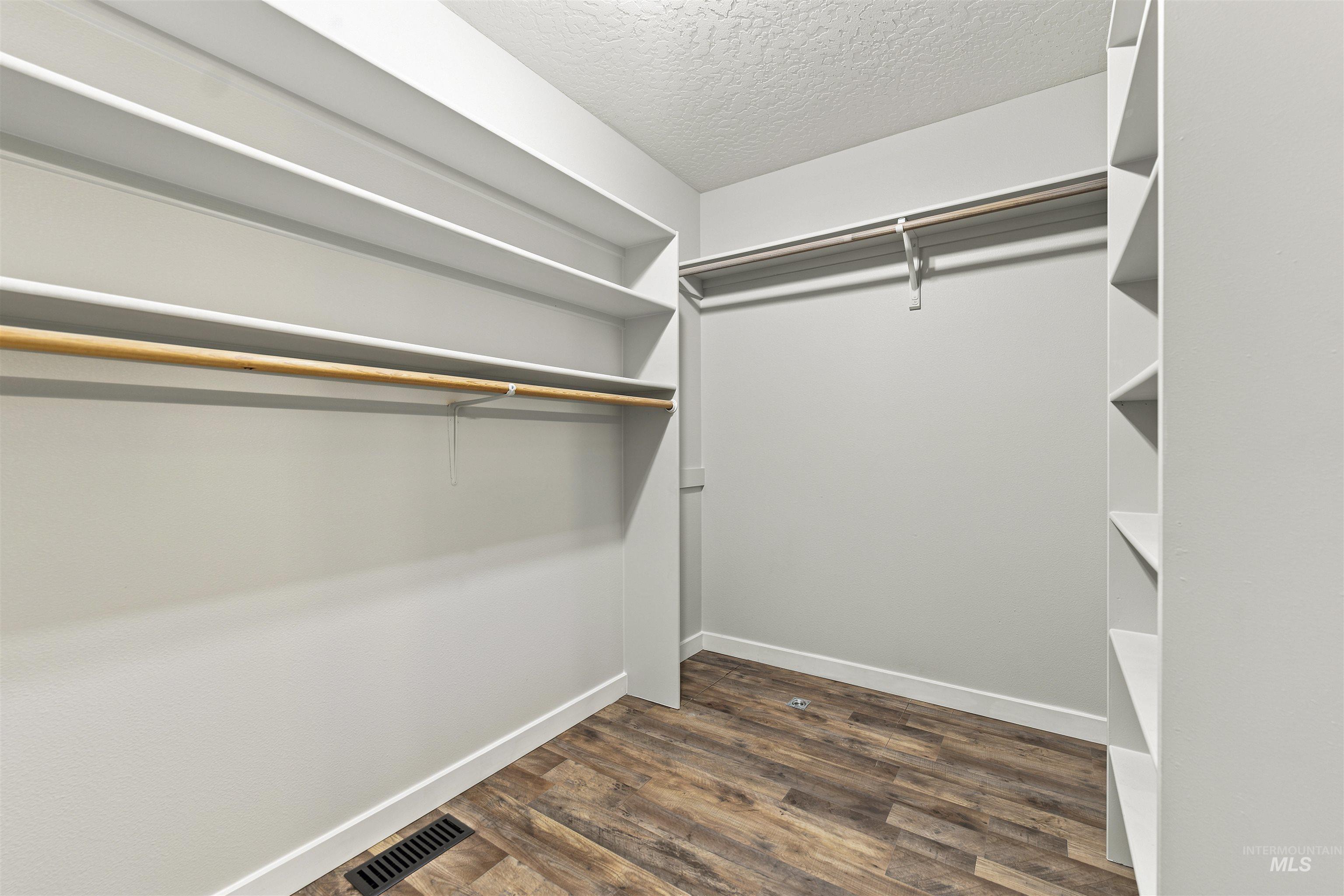 24864 Coventry Drive Caldwell, ID 83607 - Photo 29 of 49 Spacious walk-in closet featuring wood-finish flooring