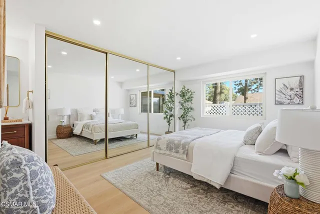 a bedroom with a large bed and a large window