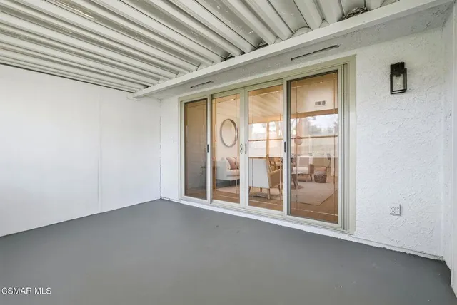 a view of an empty room with glass door