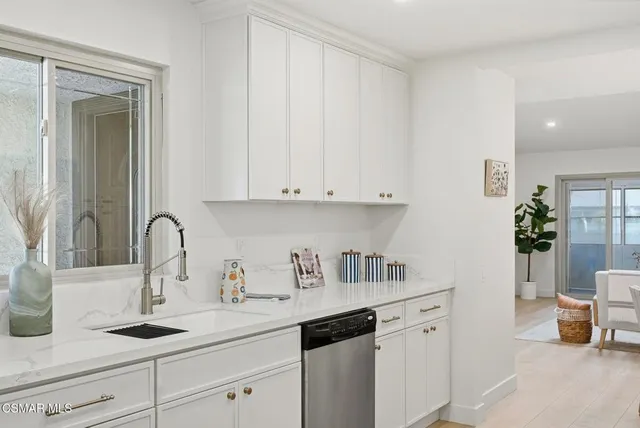 a kitchen with sink and cabinets