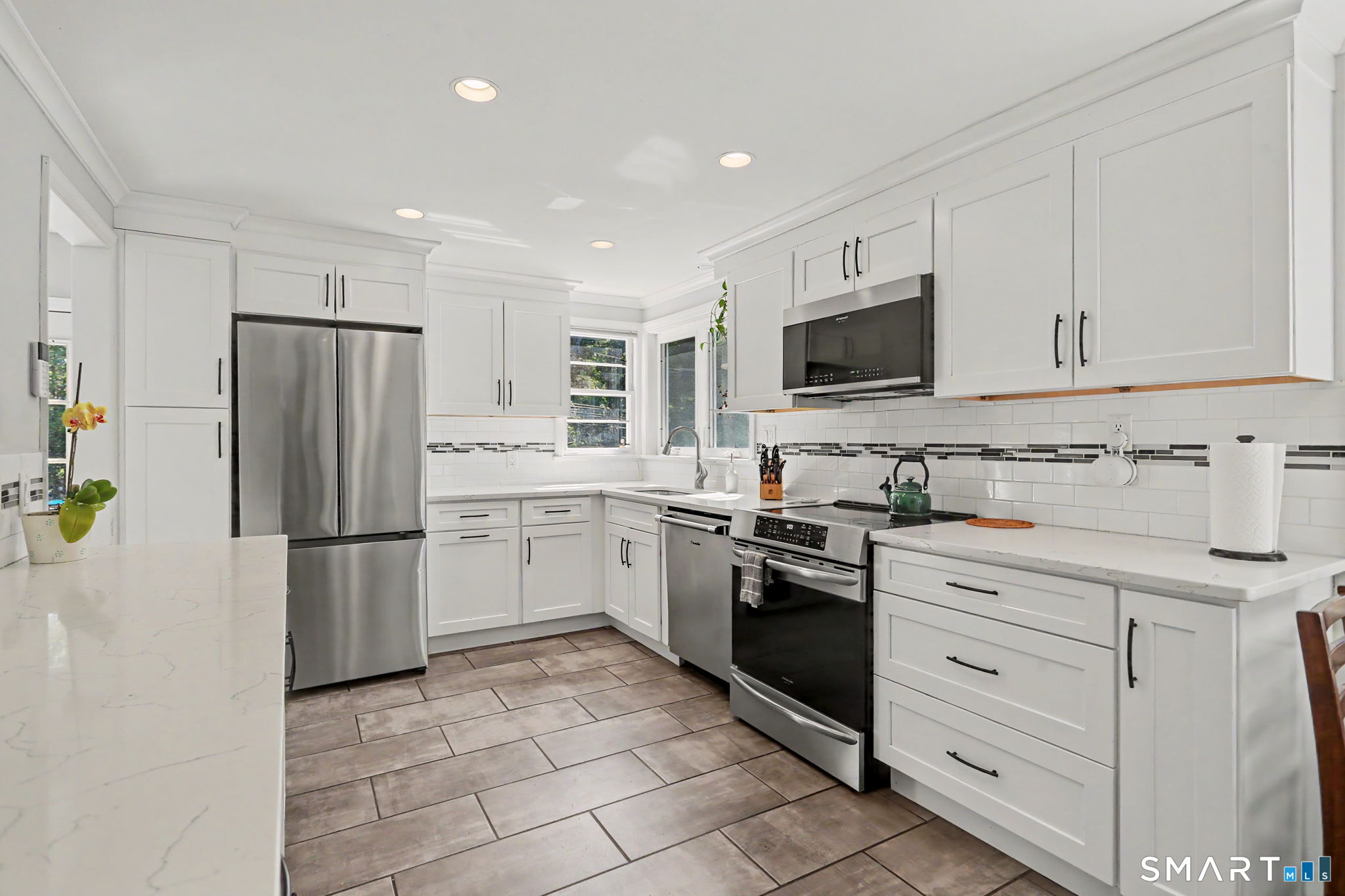 2 Rising Road Norwalk, CT 06850 - Photo 9 of 33 a kitchen with granite countertop a refrigerator stove and microwave