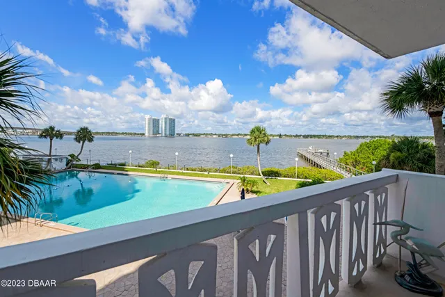 a view of swimming pool with outdoor seating and city view