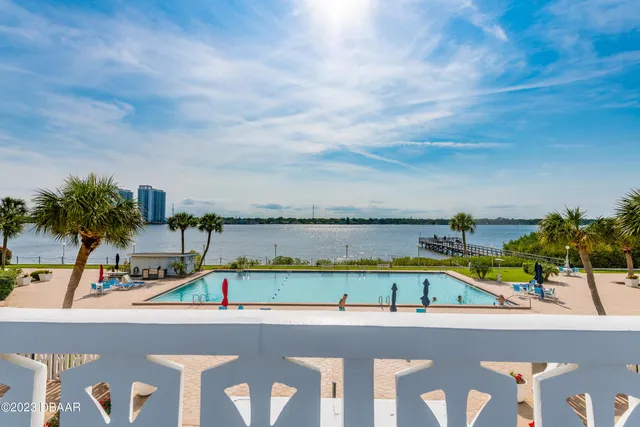 a view of a swimming pool with a lawn chairs