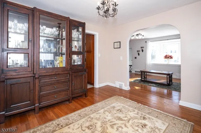a view of a room with wooden floor and window