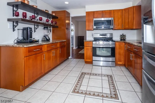 a kitchen with stainless steel appliances granite countertop a stove a sink and dishwasher