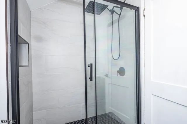 a bathroom with a glass shower door