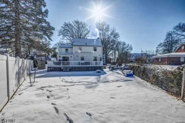 a view of a house with snow on the road