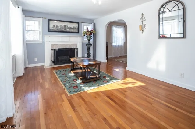 a view of a livingroom with wooden floor and a fireplace