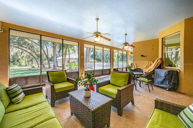 a living room with furniture and a floor to ceiling window