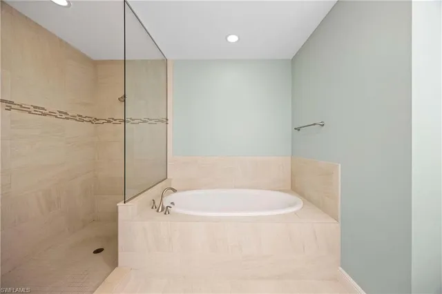 a white bath tub sitting in a bathroom
