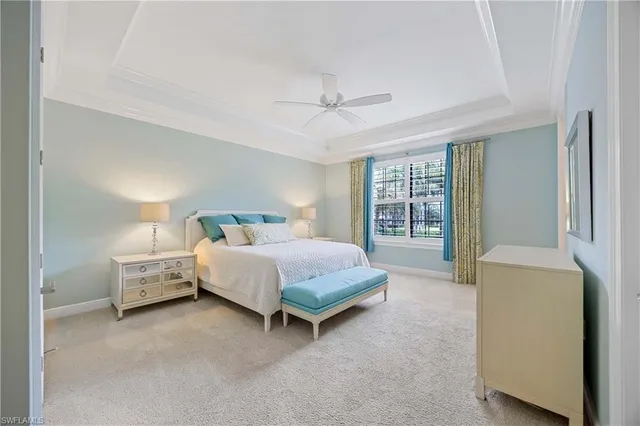 a spacious bedroom with a bed and a chandelier