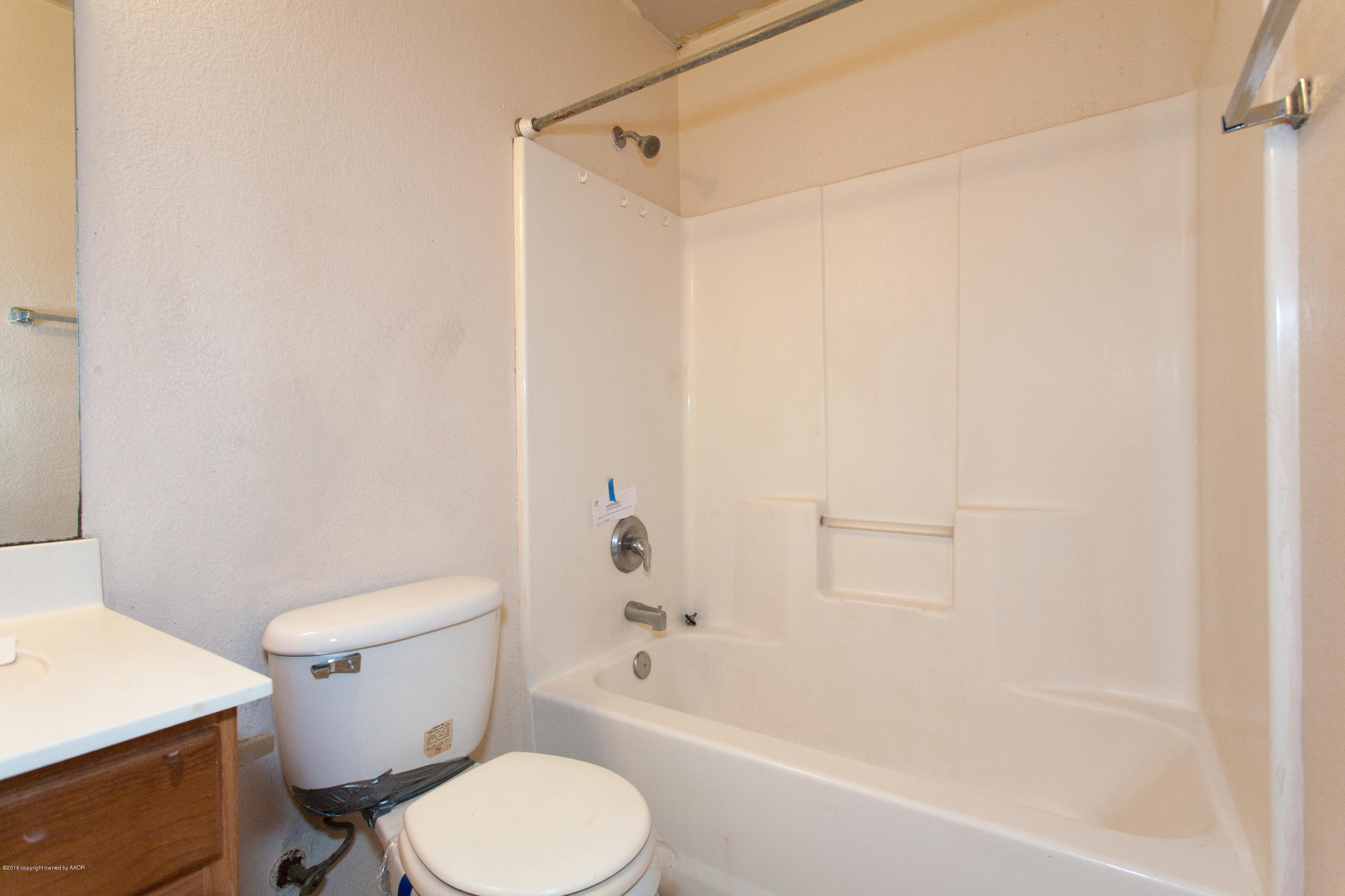4810 Mammoth Lane Amarillo, TX 79110 - Photo 12 of 14 a white toilet sitting next to a bath tub
