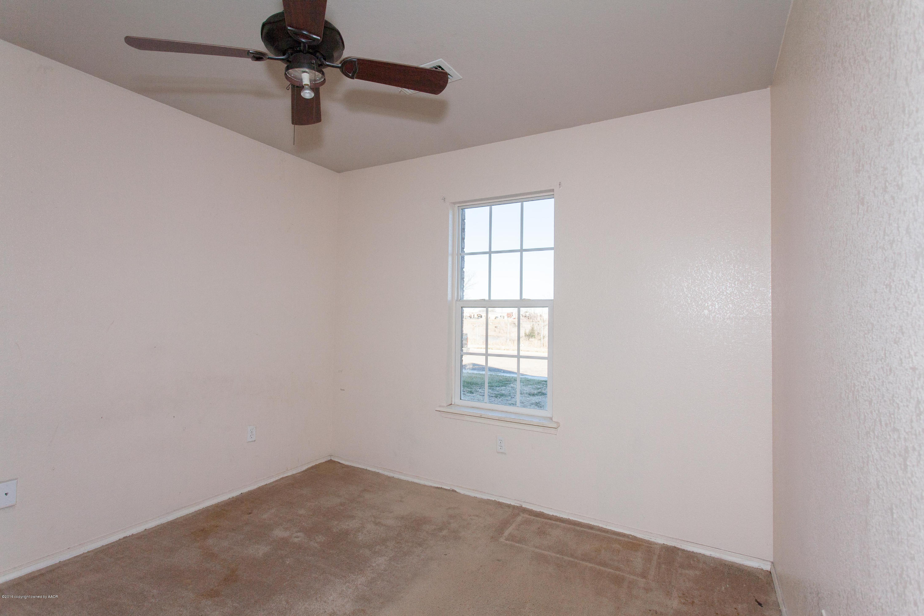 4810 Mammoth Lane Amarillo, TX 79110 - Photo 14 of 14 an empty room with windows and fan
