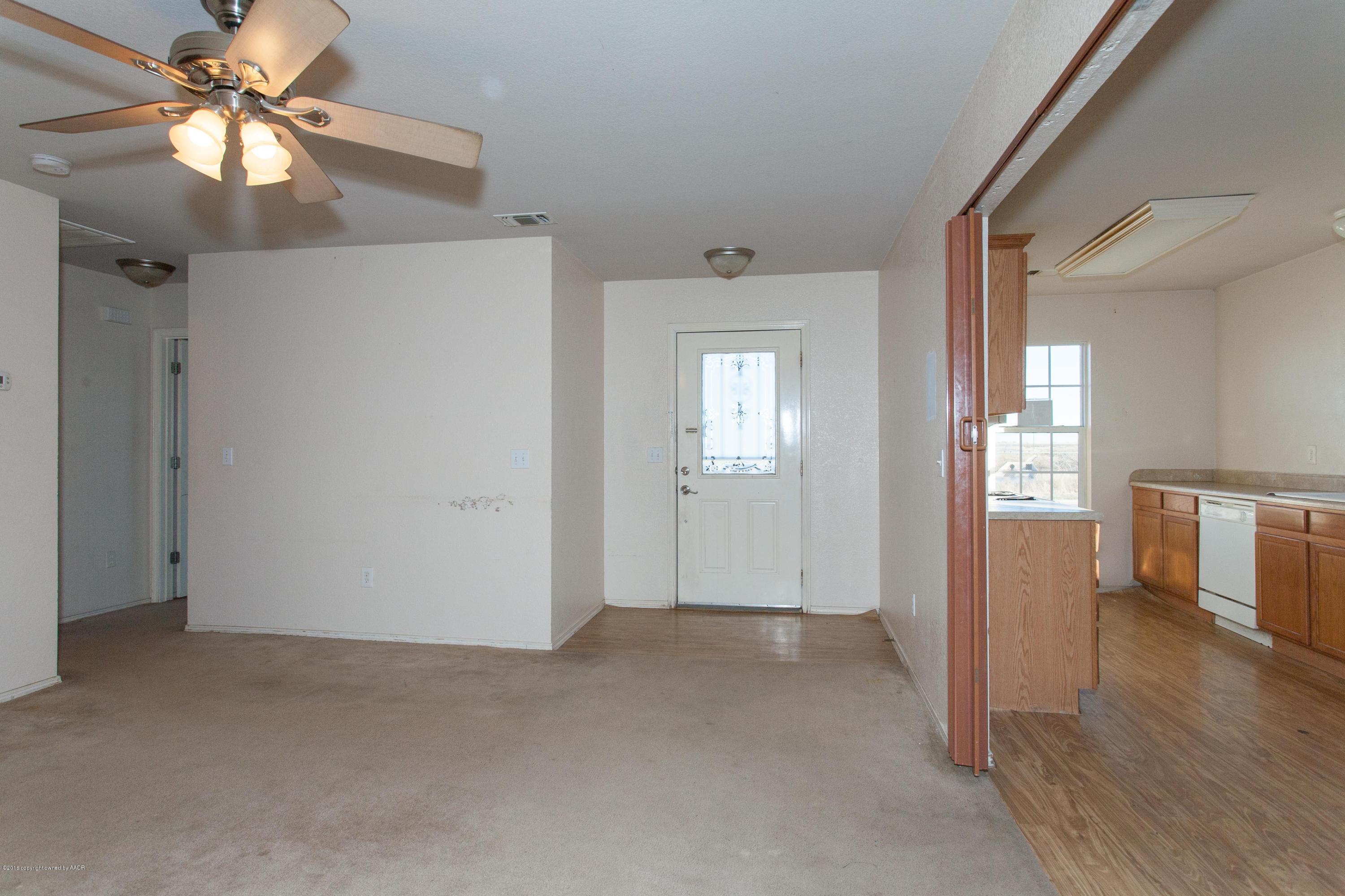 4810 Mammoth Lane Amarillo, TX 79110 - Photo 2 of 14 wooden floor in an empty room with a window