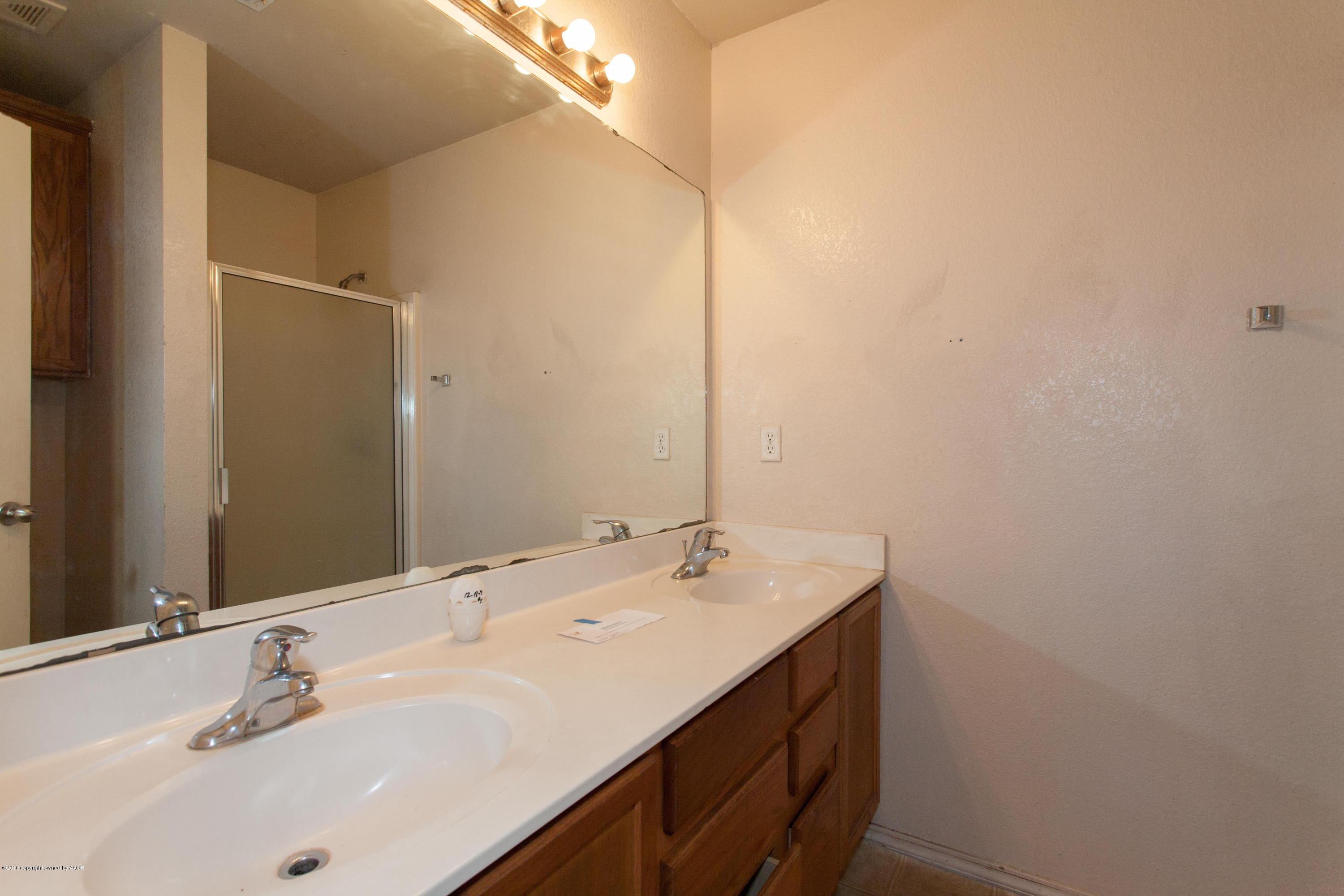 4810 Mammoth Lane Amarillo, TX 79110 - Photo 9 of 14 a bathroom with a sink and a mirror