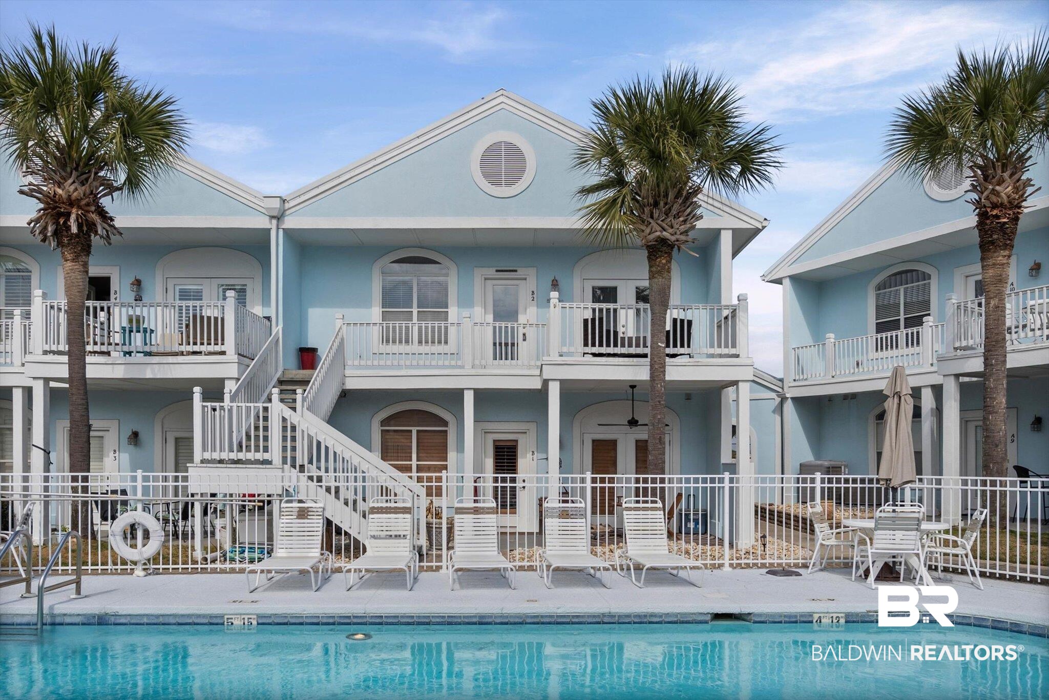 3575 Bayou Road, Unit B2 Orange Beach, AL 36561 - Photo 34 of 35 Rear view of property featuring stucco siding, a community pool, and a patio area