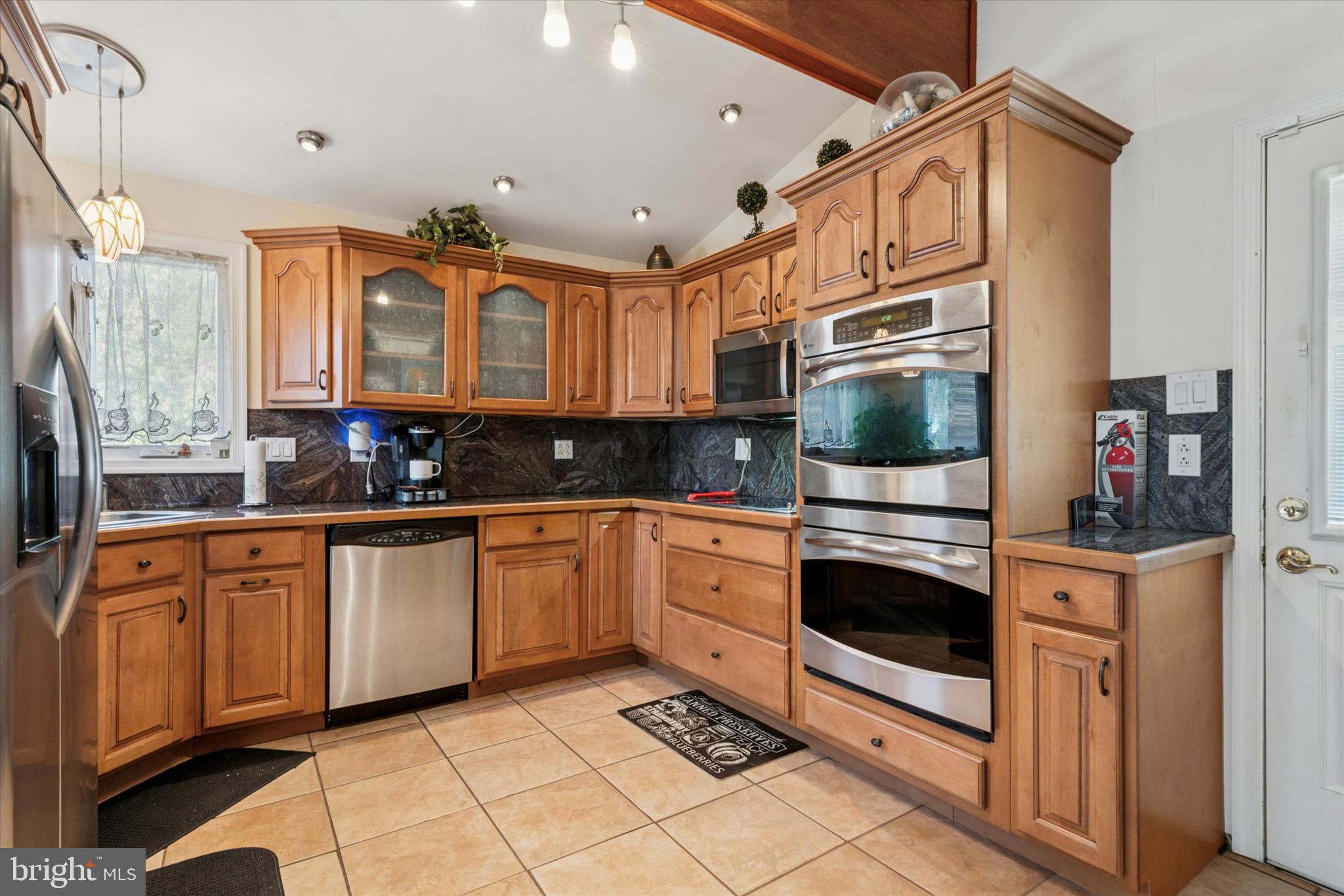 29 Harkfort Road Newark, DE 19702 - Photo 6 of 25 a kitchen with stainless steel appliances granite countertop a stove a sink and a microwave