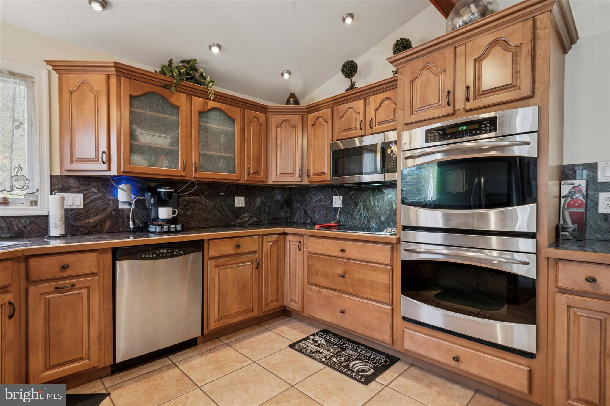 29 Harkfort Road Newark, DE 19702 - Photo 7 of 25 a kitchen with stainless steel appliances granite countertop a stove a sink and a microwave