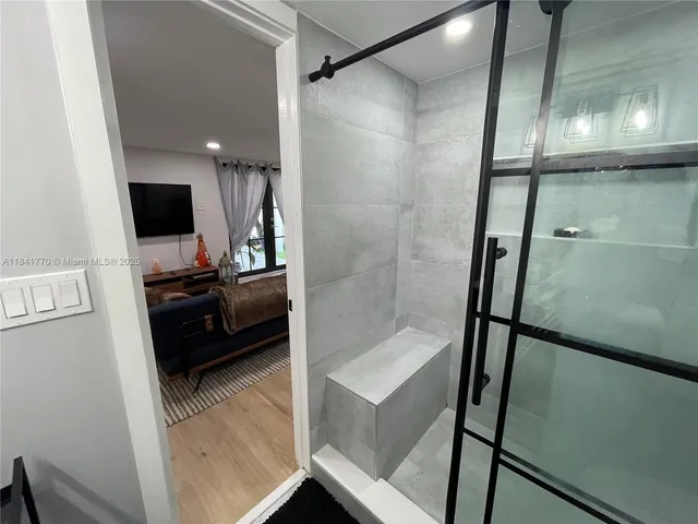 a bathroom with a glass shower door and a sink