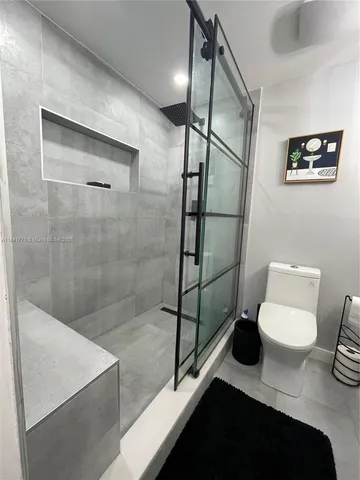 a bathroom with a toilet and a shower