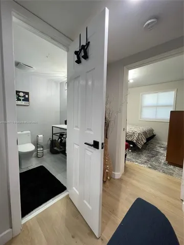 a bedroom with a bed and a view of living room