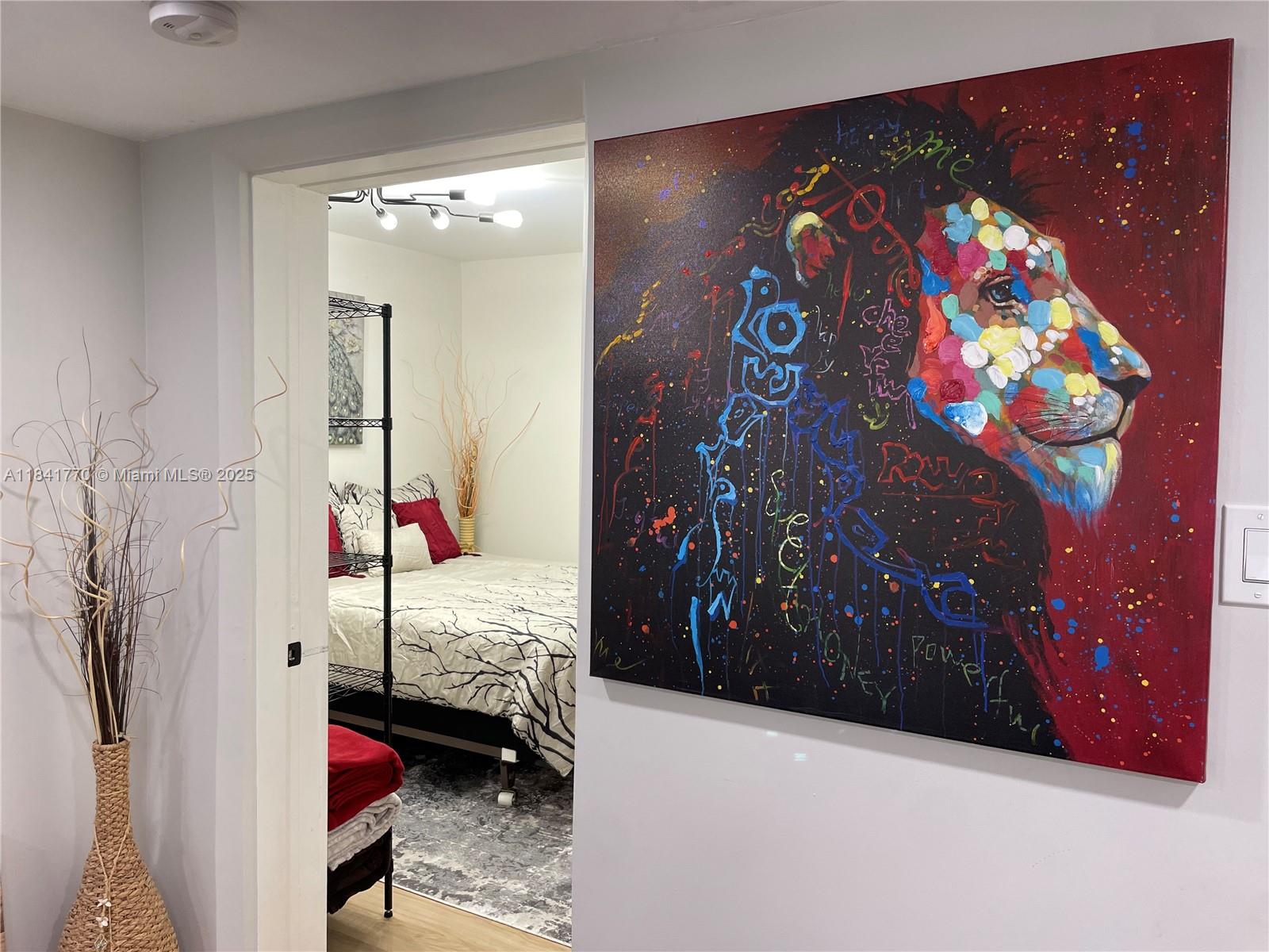 8525 Franjo Road, Unit 2 Cutler Bay, FL 33189 - Photo 2 of 23 a bedroom with a bed and a painting on the wall