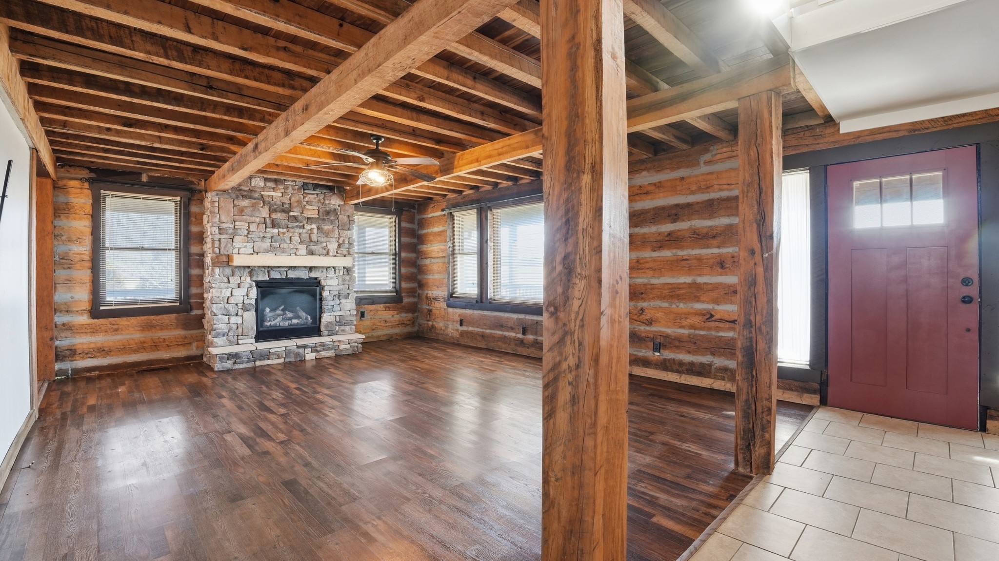 4669 Griffin Road Lynchburg, TN 37352 - Photo 8 of 43 an empty room with wooden floor fireplace and windows