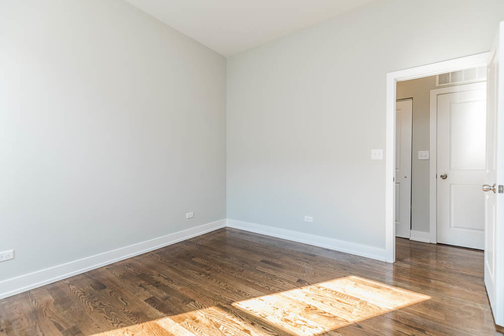 2228 West Cermak Road Chicago, IL 60608 - Photo 13 of 32 a view of a room with wooden floor and white walls