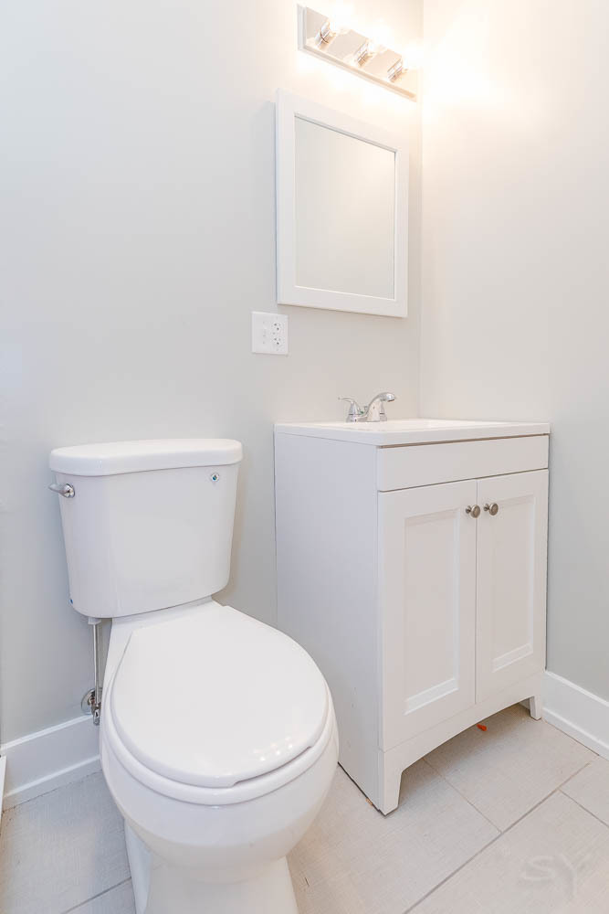 2228 West Cermak Road Chicago, IL 60608 - Photo 18 of 32 a white toilet sitting next to a bathroom sink