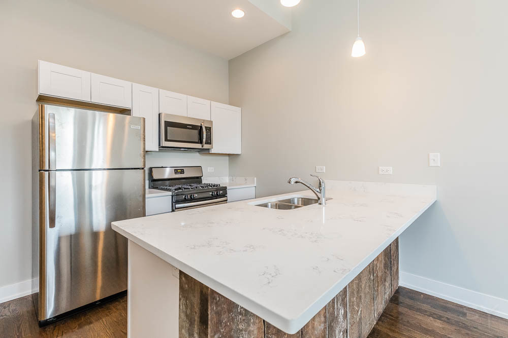 2228 West Cermak Road Chicago, IL 60608 - Photo 2 of 32 a kitchen with a refrigerator and a sink