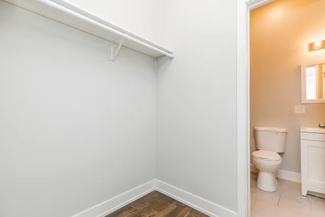 a view of a house with a small yard and wooden floor and fence