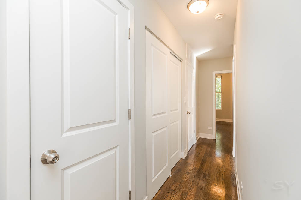 2228 West Cermak Road Chicago, IL 60608 - Photo 25 of 32 a view of a hallway with wooden floor