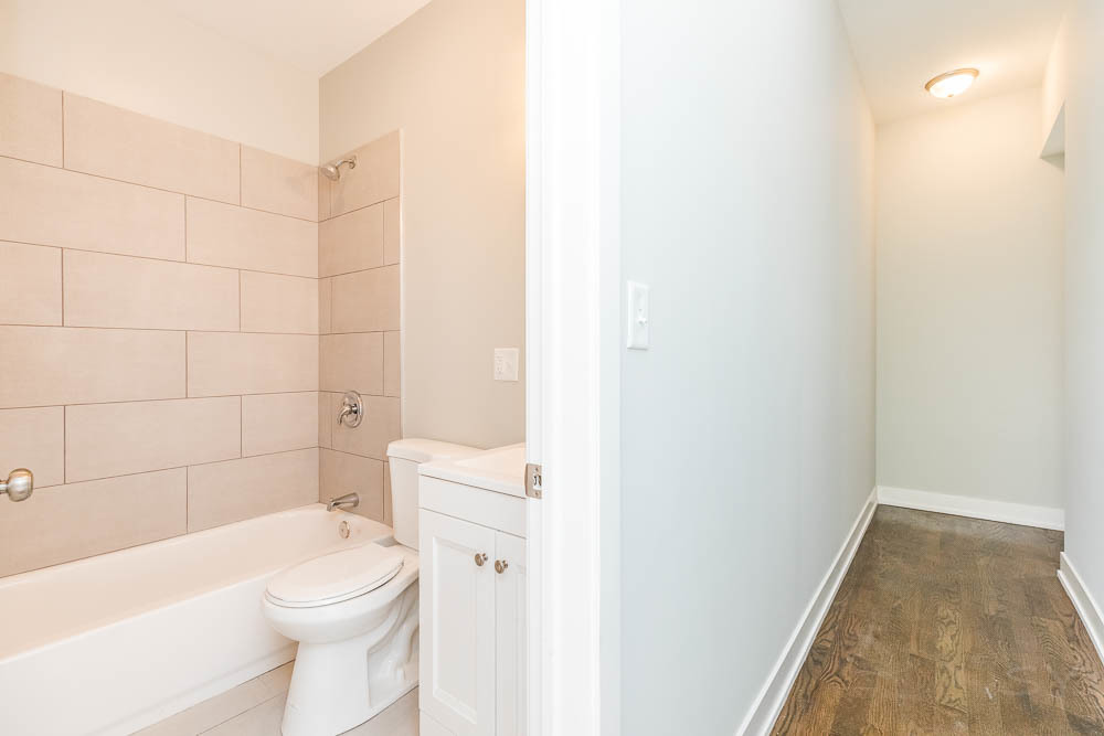 2228 West Cermak Road Chicago, IL 60608 - Photo 26 of 32 a white toilet sitting next to a bath tub