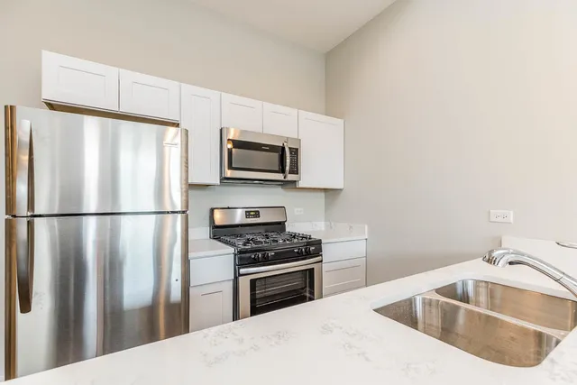 a kitchen with a sink a refrigerator and washer